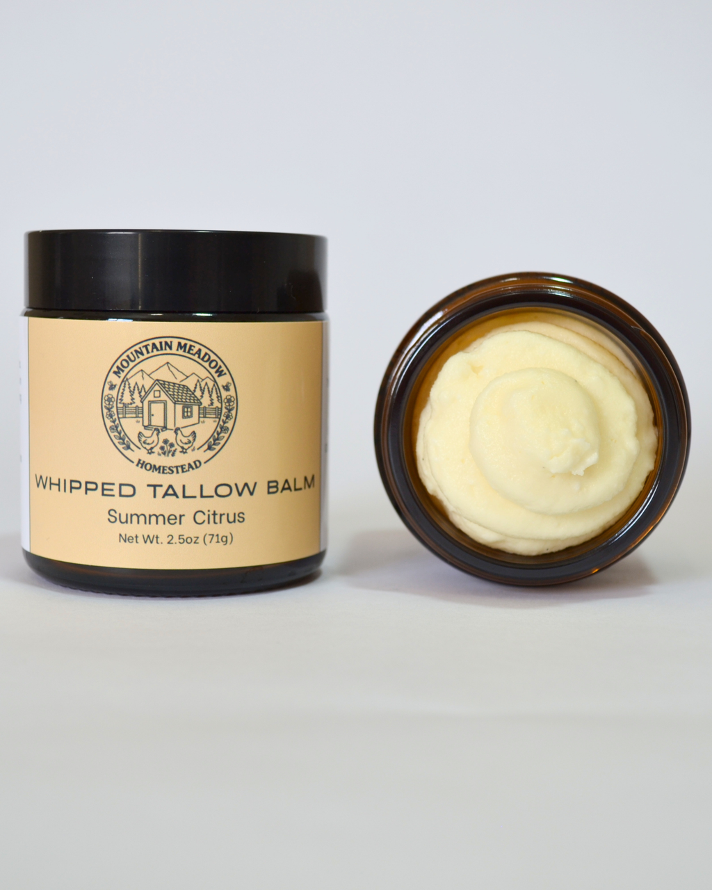 Summer Citrus Whipped Tallow Balm Inside View. Amber Jar with black lid and yellow label. Creamy