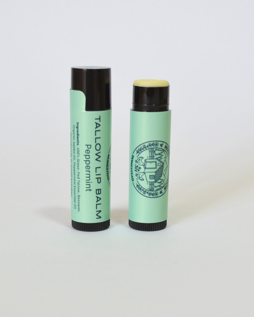 Two green lip balms with black caps on a white background, Peppermint tallow lip balm