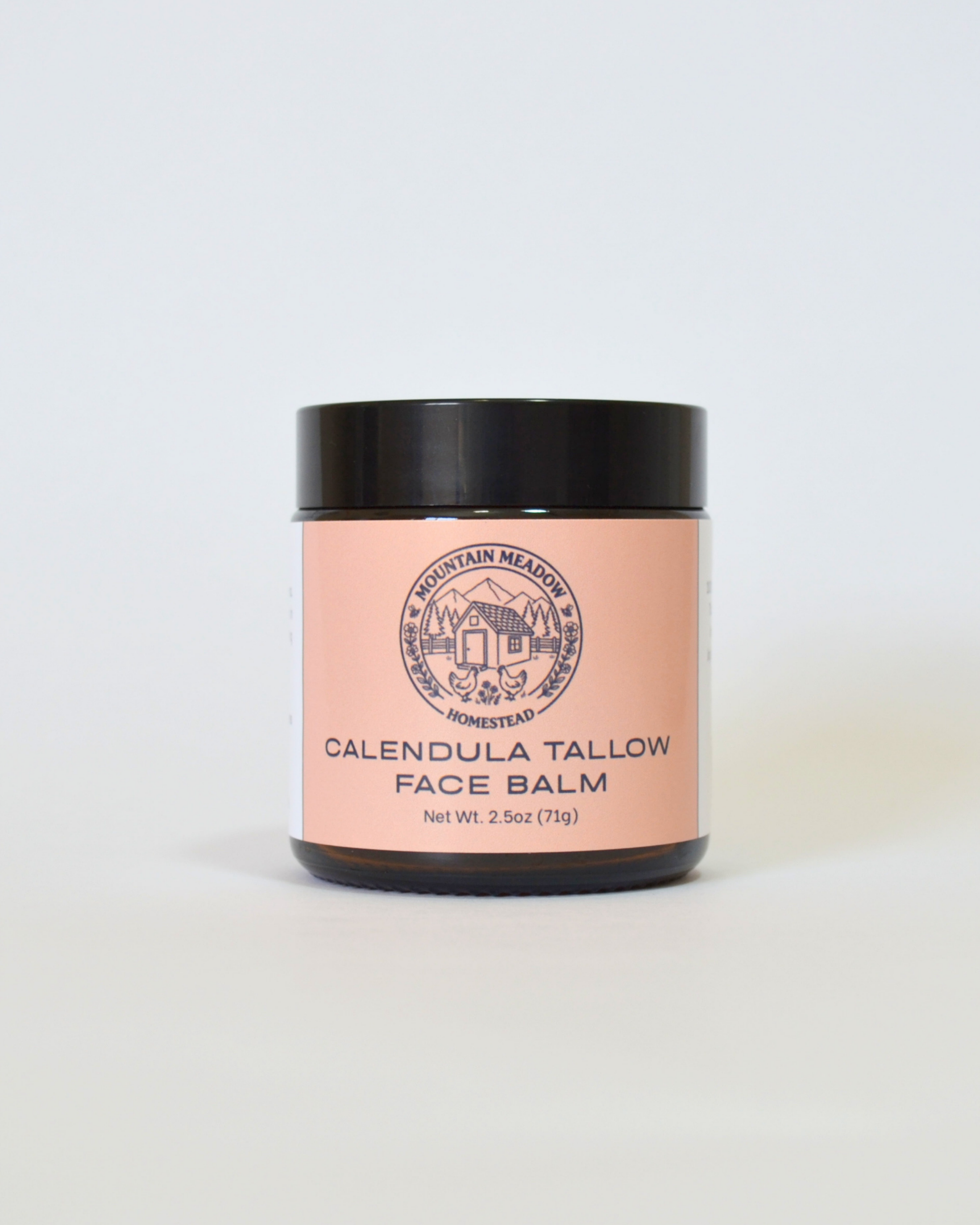 Jar of Calendula Tallow Face Balm with a pink label on a white background