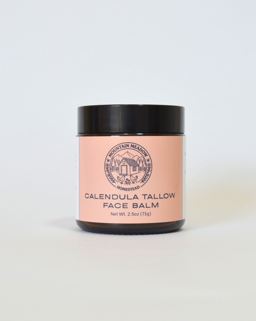Jar of Calendula Tallow Face Balm with a pink label on a white background