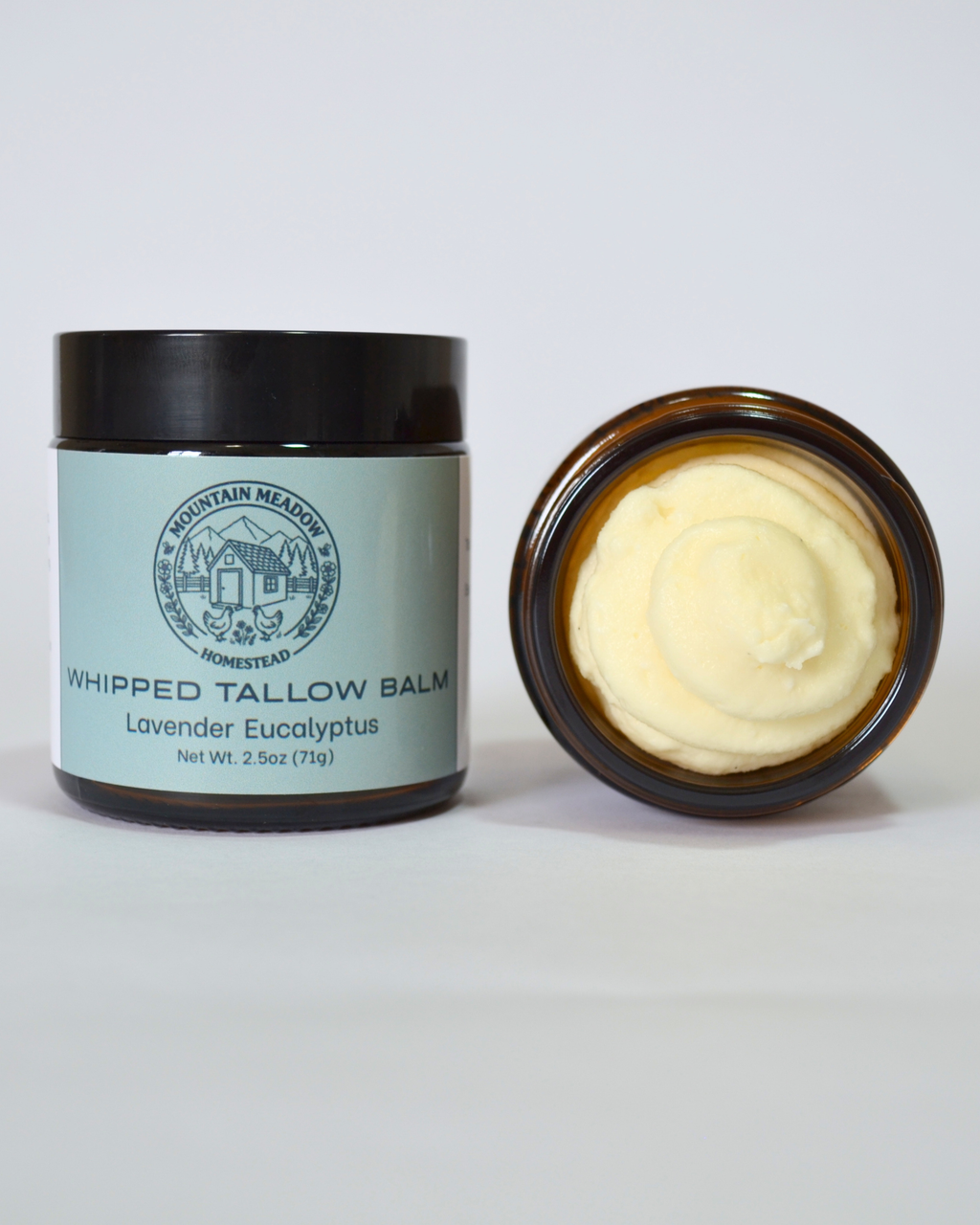 Lavender Eucalyptus Whipped Tallow Balm inside View. Amber Jar with black lid and light green label. creamy tallow