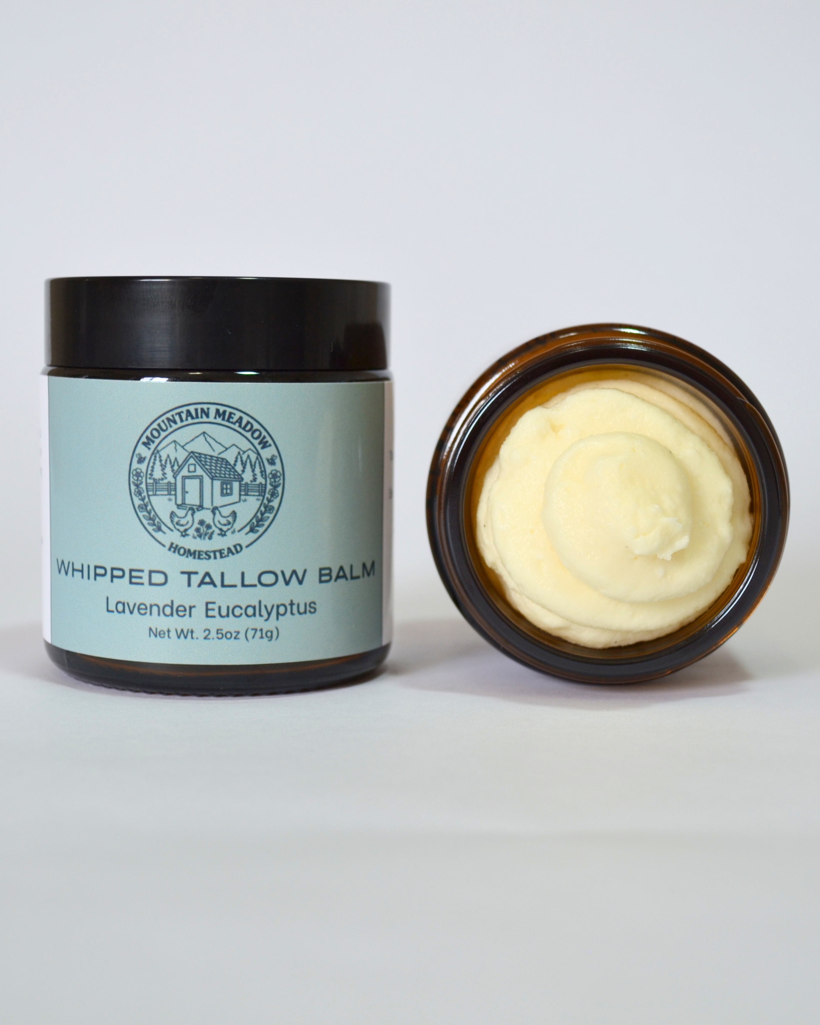 Lavender Eucalyptus Whipped Tallow Balm inside View. Amber Jar with black lid and light green label. creamy tallow