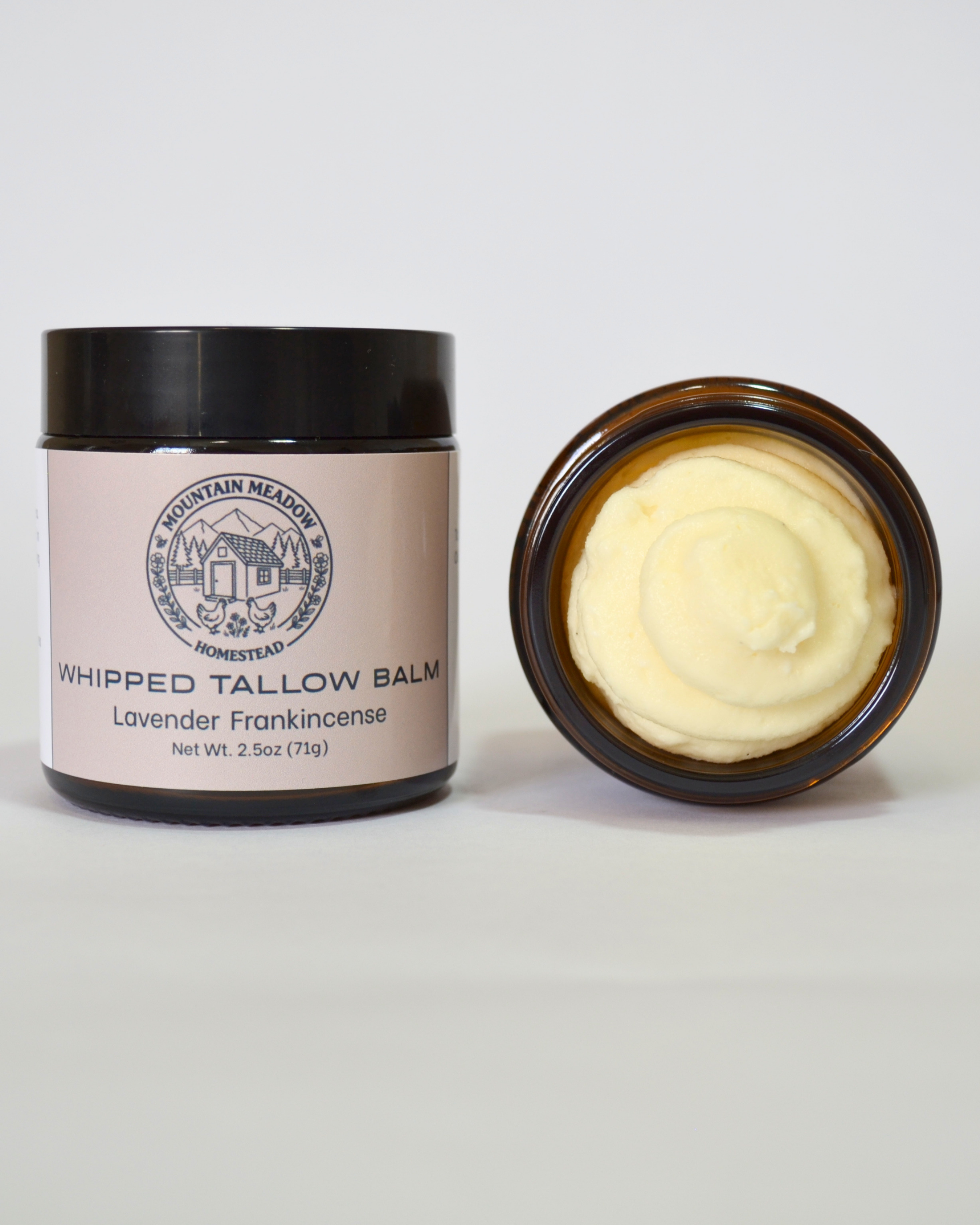 Lavender Frankincense Whipped Tallow Balm inside View. Amber Jar with black lid and  light brown label. creamy tallow